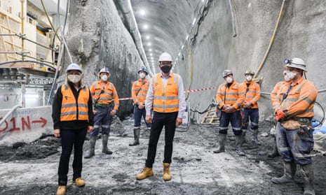 Jacinta Allan (left) and Daniel Andrews (centre) pose with workers at a section of the Metro Tunnel project in Melbourne in 2020