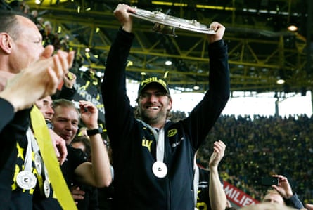 The Borussia Dortmund manager, Jürgen Klopp, hoists the Bundesliga trophy after his team won the title in May 2012.