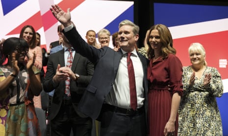 Keir Starmer, the leader of Britain's Labour Party waves next to his wife Victoria after making his speech at the party's annual conference in Liverpool.