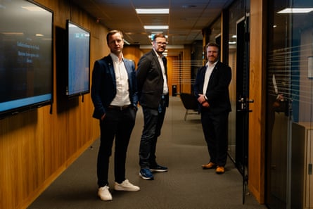 Lars Benjamin Vold, Øystein Brekke-Sanderud and Øyvind Berget standing in a wood-panelled corridor