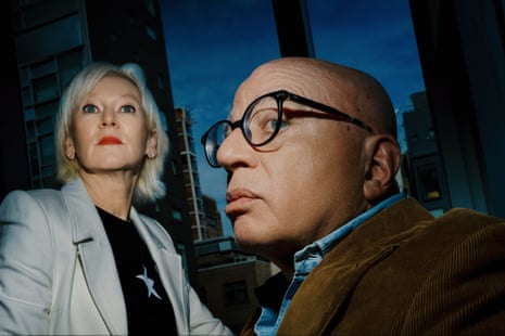 A man and a woman look up into the air