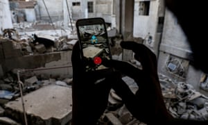 AFP PICTURES OF THE YEAR 2016
A Syrian gamer uses the Pokemon Go application on his mobile to catch a Pokemon amidst the rubble in the besieged rebel-controlled town of Douma, a flashpoint east of the capital Damascus on July 23, 2016. / AFP PHOTO / Sameer Al-DoumySAMEER AL-DOUMY/AFP/Getty Images