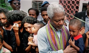 Former UN secretary-general comforts a crying child among a group of survivors of the Liquica massacre in East Timor in 1999.