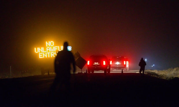 Three SUVs proceed through the roadblock near Burns, Oregon, as FBI agents surround the remaining four occupiers at the Malheur national wildlife refuge.