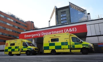 Two ambulances parked in front of a hospital with a sign saying 'Emergency Department (A&E)'