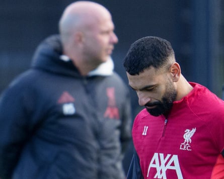 Britain Champions League SoccerLiverpool's Mohamed Salah passes manager Arne Slot, left, as he takes part in a training session in Liverpool, England, Monday, Dec. 8, 2025. (AP Photo/Jon Super)