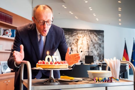 German chancellor Friedrich Merz blows out some candles on a birthday cake he received by staff of the Chancellery on the occasion of his 70th birthday in Berlin, Germany.