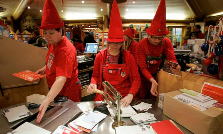 People dressed as elves post mark letters with the stamp from Santa Claus' Post Office on the Arctic Circle near Rovaniemi, northern Finland, December 18, 2007. REUTERS/Kacper Pempel (FINLAND)
