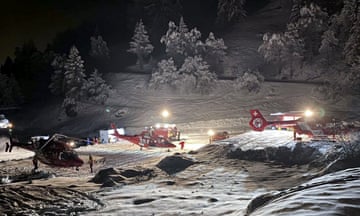 Mountain rescuers and helicopters in the Swiss Alps