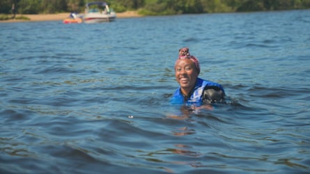 Scarlette Douglas smiling as she swims wearing a headscarf and cold water gear