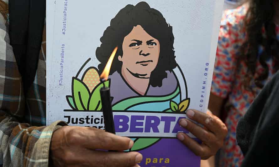 A member of Indigenous rights organisation Copinh holds a candle while waiting for the sentencing of Roberto David Castillo, the businessman found guilty of collaborating in the murder of environmental defender Berta Caceres.