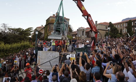 Cheering students surround a statue of British colonialist Cecil Rhodes, as it is removed from the campus at the Cape Town University, South Africa, in 2015. 