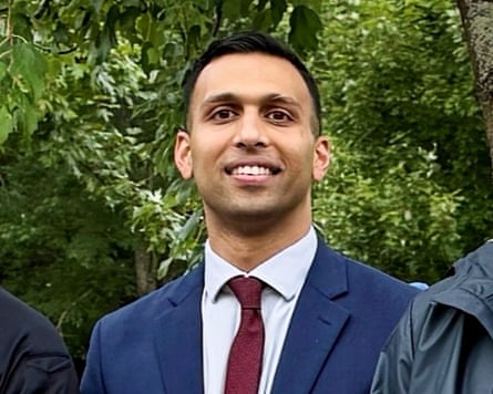 a man in a suit smiles