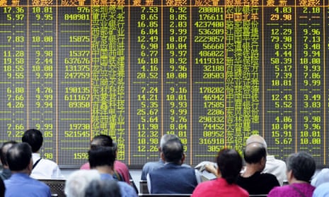 Investors sit in front of a screen showing market movements in a stock firm in Hangzhou, eastern China’s Zhejiang province on July 8, 2015.
