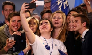 French presidential candidate Marine Le Pen poses for a selfie with young supporters on 2 April in Bordeaux.