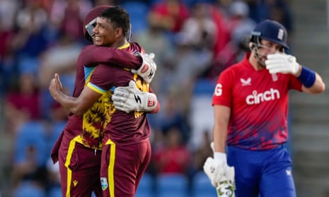 West Indies' Gudakesh Motie celebrates with Nicholas Pooran after taking the wicket of England's Liam Livingstone (right).