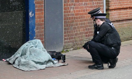Two police officers speak to a homeless person in Winchester, Hampshire