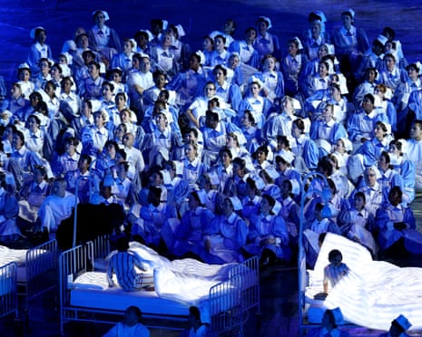 Olympic performers and volunteers dressed as NHS nurses.