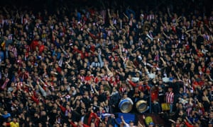 The Atlético fans cheer on their team.