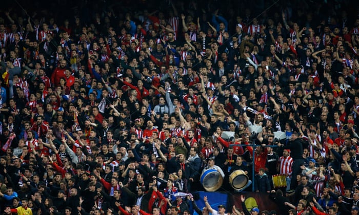 The Atlético fans cheer on their team.