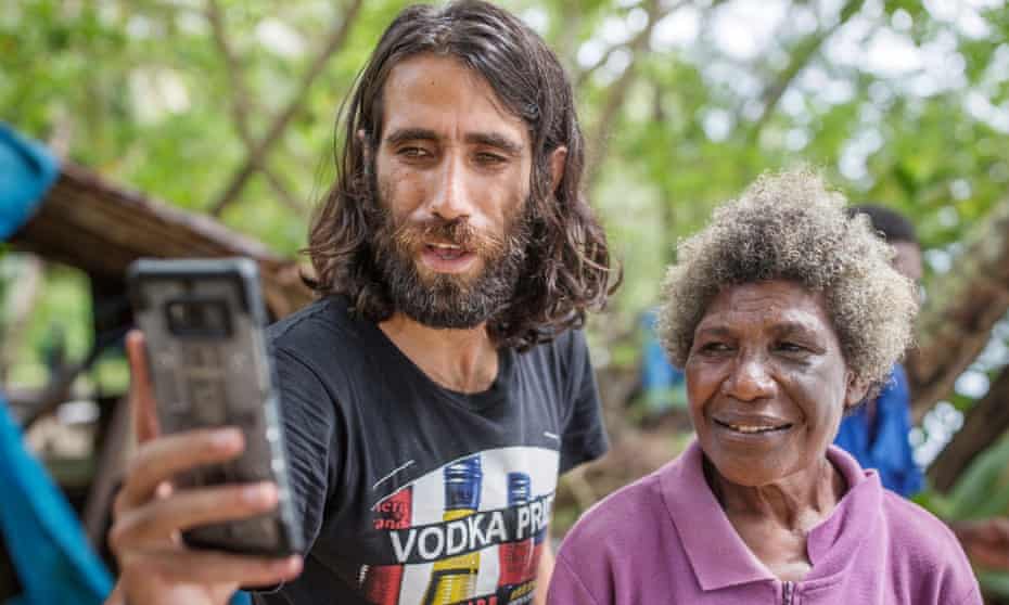 Behrouz Boochani takes a selfie with one of the locals on Manus Island