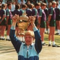 A 17-year-old Boris Becker holds the Wimbledon trophy aloft.