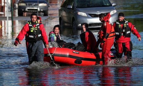 First responders pull local residents in a boat in Mamaroneck, New York