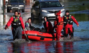First responders pull local residents in a boat in Mamaroneck, New York