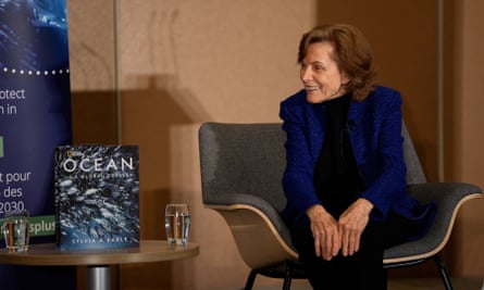 Sylvia Earle sits next to her book, Ocean: A global odyssey