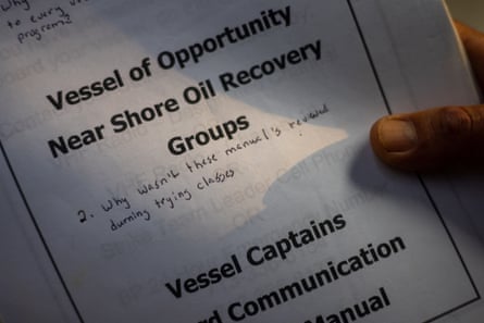 hand holds document that says 'vessel of opportunity near shore oil recovery groups'. Below that handwriting says: 'why wasn't these manuals reviewed during training classes'
