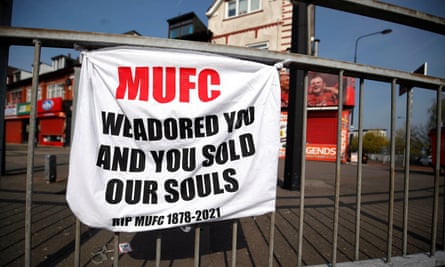 A banner left by Manchester United fans on Sir Matt Busby Way reading: 'MUFC We adored you and you sold our souls. RIP MUFC 1878-2021'