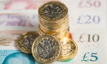 A £5, £10, £20 and £50 note with one-pound coins
