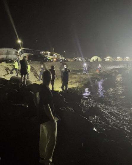 Police speaking to protesters in the water at Eastney near Portsmouth.