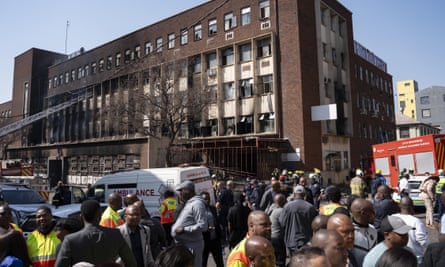 Firefighters and healthcare professionals on Thursday outside the building