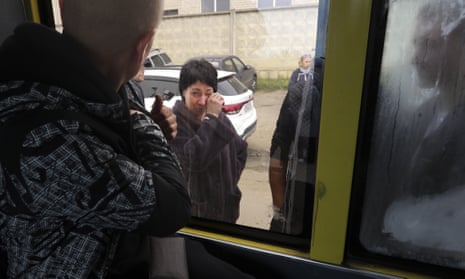 A Russian recruit looks through a bus window at his mother at a military recruitment center in Volgograd, Russia.