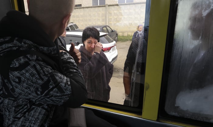 A Russian recruit looks through a bus window at his mother at a military recruitment center in Volgograd, Russia.