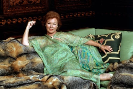 A woman on a sofa draped with furs