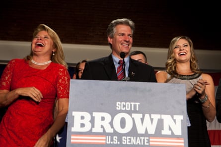 Two women flank a man on stage