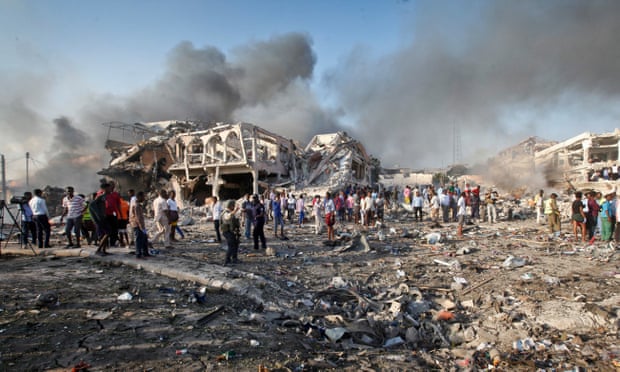 Somalis gather and search for survivors by destroyed buildings in the truck bombing in Mogadishu in October.