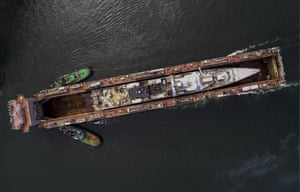 A warship is transported by a floating dock in Vladivostok, Russia