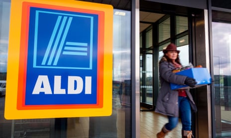 Woman with box of shopping leaves an Aldi store