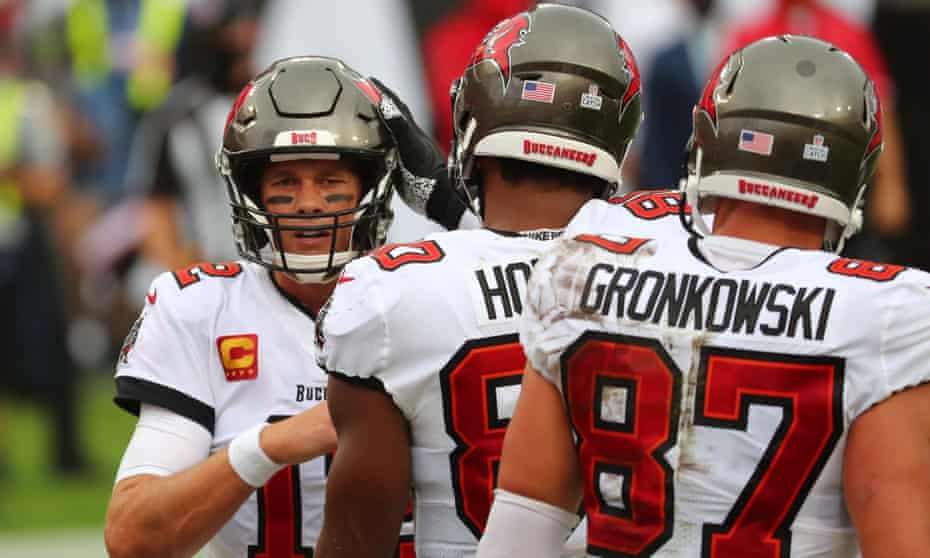 Tom Brady is congratulated by Tampa Bay Buccaneers tight ends OJ Howard and Rob Gronkowski