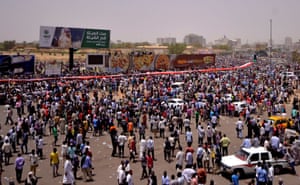 Crowds gather after Sudan's defence minister and army general, Ahmed Awad Ibn Auf, announces that President Omar al-Bashir has been detained and that a military council will run the country.