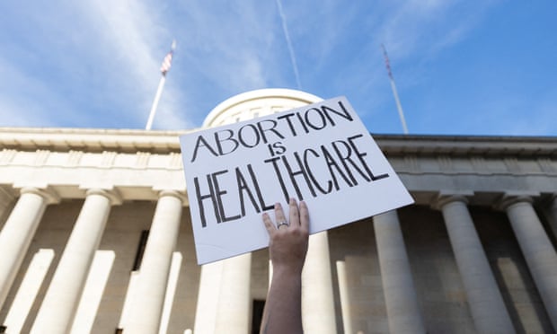 An abortion rights protester holds a sign at a rally in Columbus, Ohio.