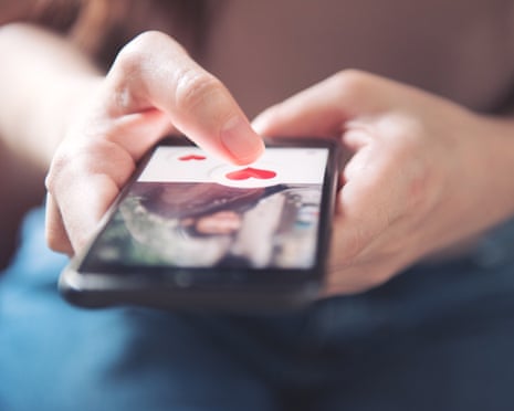 Finger of woman pushing heart icon on screen in mobile smartphone application