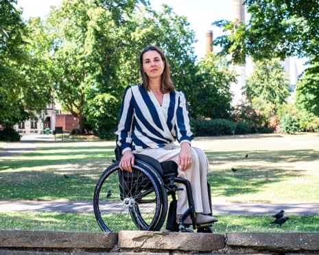 Samanta Bullock sitting in her wheelchair in a park, surrounded by trees and green grass