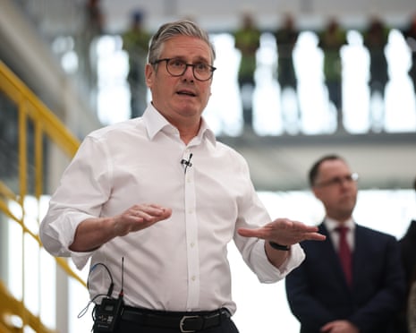 Keir Starmer speaks to workers during a visit to Glass Futures in St Helens, Merseyside.