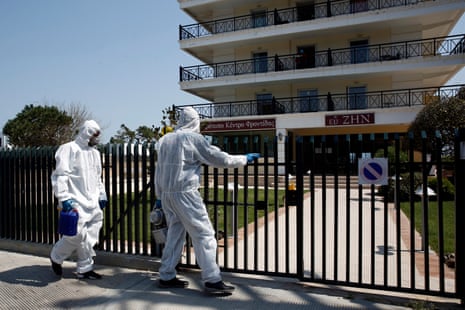A disinfecting crew enters a retirement home in Nea Makri, east of Athens, Greece