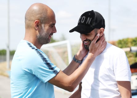 Manchester City’s new signing Riyad Mahrez is greeted by manager Pep Guardiola on his first day.