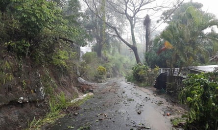 Debris covers a road after heavy rains from tropical storm Erika